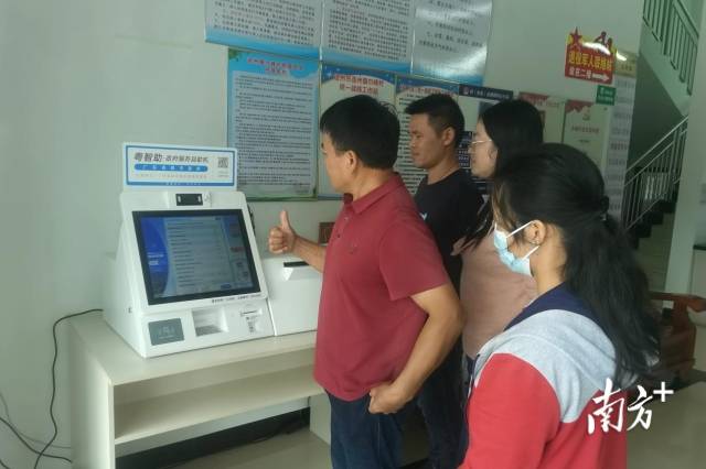 村民老張豎起大拇指點贊“粵智助”政府服務自助機。通訊員供圖